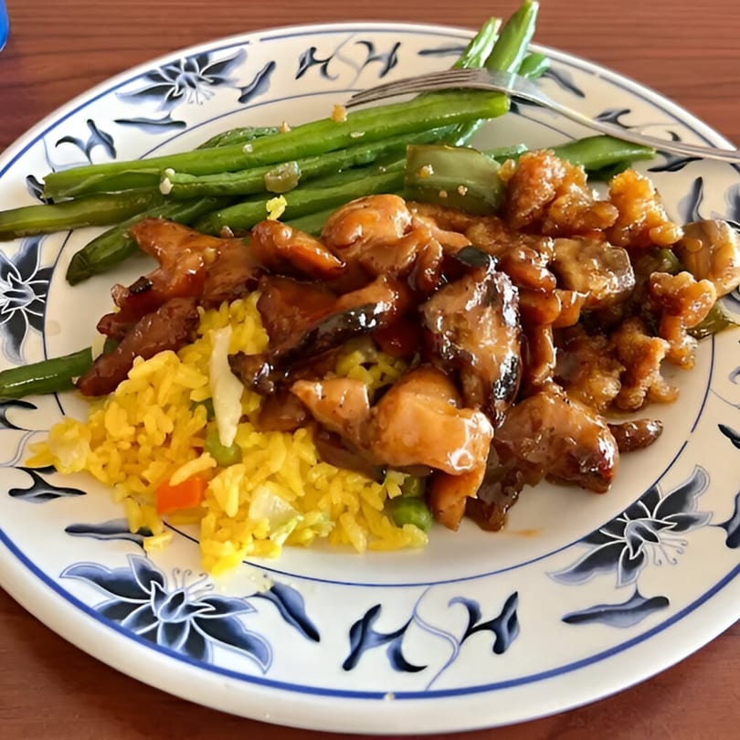 Asian Garden Buffet plate with orange chicken, yellow fried rice, and green beans.