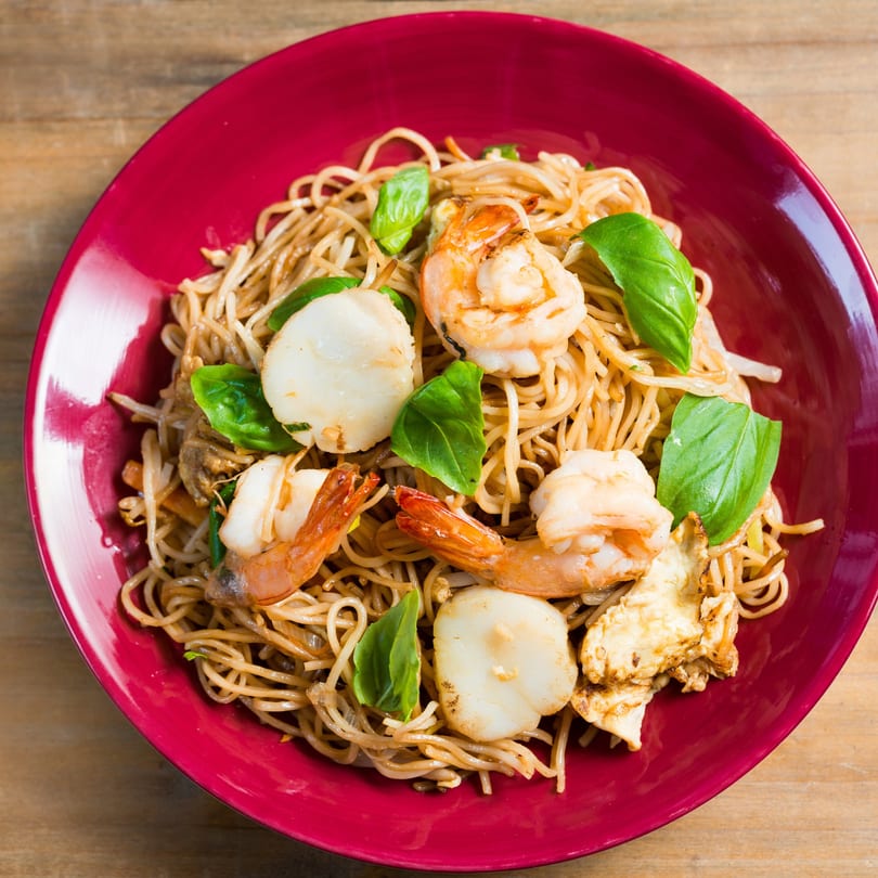 Asian Garden Buffet's seafood lo mein with shrimp, scallops, and basil in a red bowl.